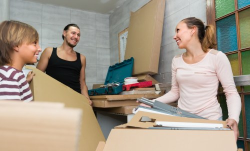 Furniture removal crew loading sofas and chairs during a Kingston pickup