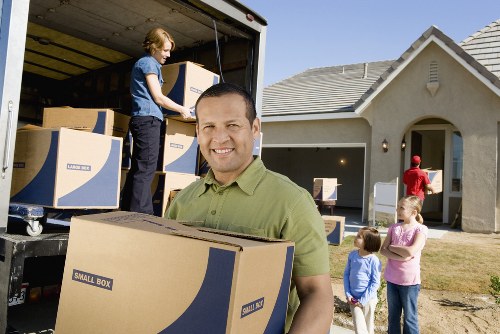 Supervisor reviewing safety checks beside a removal van